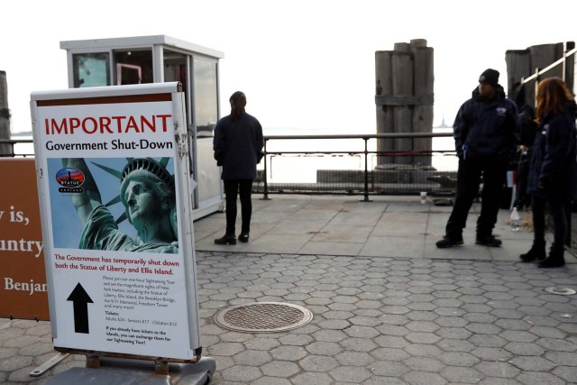 FILE PHOTO: A sign announcing the closure of the Statue of Liberty, due to the U.S. government shutdown, sits near the ferry dock to the Statue of Liberty at Battery Park in Manhattan, New York, U.S. January 21, 2018. REUTERS/Shannon Stapleton/File Photo