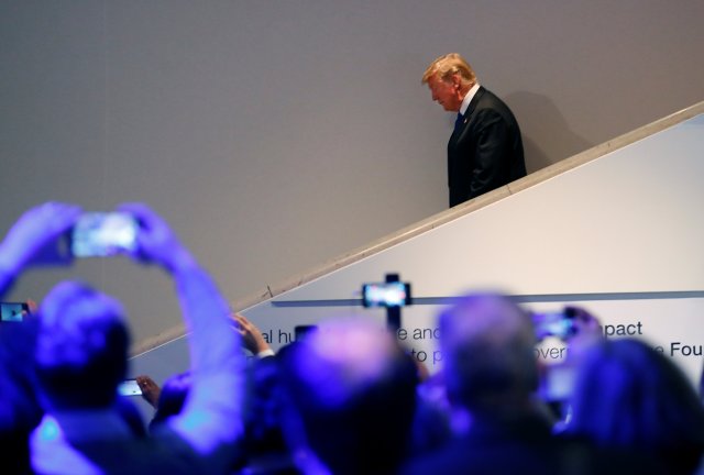 U.S. President Donald Trump walks down stairs after a round of meetings during the World Economic Forum (WEF) annual meeting in Davos, Switzerland January 25, 2018. REUTERS/Denis Balibouse