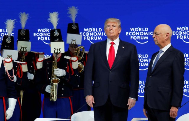 U.S. President Donald Trump and Klaus Schwab, Founder and Executive Chairman of the WEF, listen to concert and marching band Landwehr de Fribourg, during the World Economic Forum (WEF) annual meeting in Davos, Switzerland January 26, 2018. REUTERS/Denis Balibouse