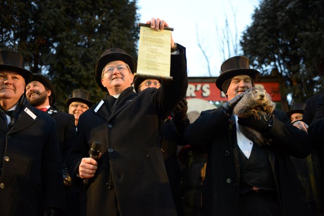 Groundhog Club Inner Circle member Jeff Lundy holds a scroll revealing Punxsutawney Phil's forecast for six more weeks of winter at Gobbler's Knob on the 132nd Groundhog Day in Punxsutawney, Pennsylvania, U.S. February 2, 2018. REUTERS/Alan Freed