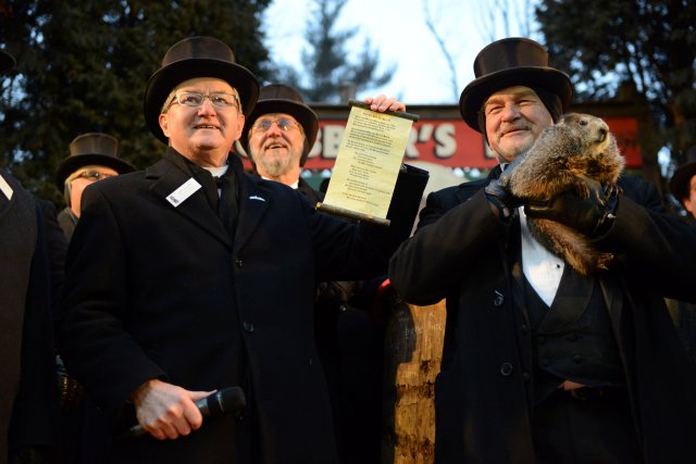 Groundhog Club Inner Circle member Jeff Lundy holds a scroll revealing Punxsutawney Phil's forecast for six more weeks of winter at Gobbler's Knob on the 132nd Groundhog Day in Punxsutawney, Pennsylvania, U.S. February 2, 2018. REUTERS/Alan Freed