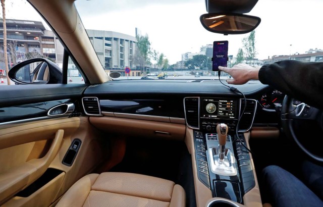 An engineer points to a Huawei Mate 10 Pro mobile used to control a driverless car during the Mobile World Congress in Barcelona, Spain February 26, 2018. REUTERS/Yves Herman