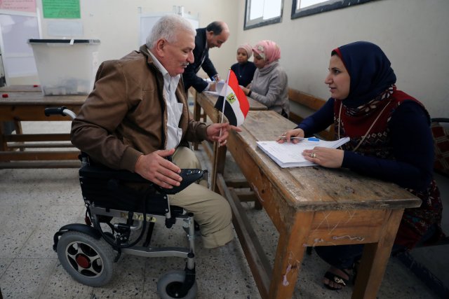 A man in a wheelchair arrives to cast his vote during the presidential election in Alexandria, Egypt March 26, 2018. REUTERS/Mohamed Abd El Ghany