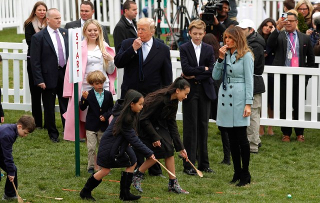President Donald Trump and first lady Melania Trump blow whistles for children gathered for the annual White House Easter Egg Roll as they stand with his daughter Tiffany and their son Barron on the South Lawn of the White House in Washington, U.S., April 2, 2018. REUTERS/Carlos Barria