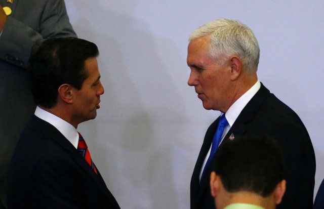 Mexico's President Enrique Pena Nieto and U.S. Vice President Mike Pence shake hands at the family photo of the VIII Summit of the Americas in Lima, Peru April 14, 2018. REUTERS/ Ivan Alvarado