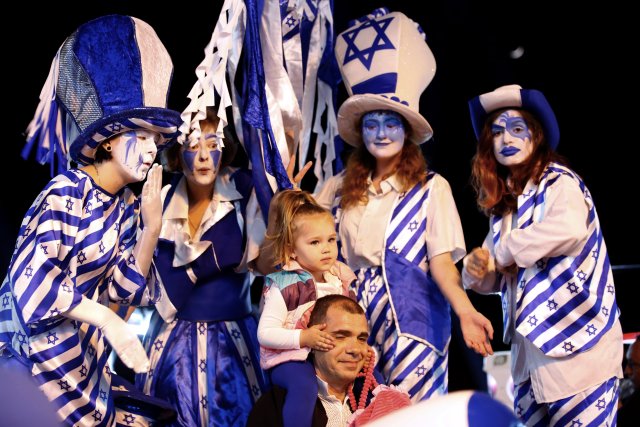 Israelis pose for a picture during celebrations marking Israel's 70th Independence Day in the southern city of Ashkelon, Israel April 18, 2018. REUTERS/Amir Cohen