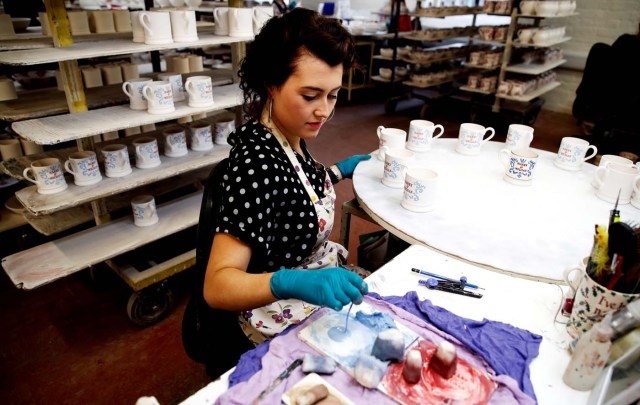 A worker prints a design onto a souvenir mug to commemorate the wedding of Britain's Prince Harry and Meghan Markle at the Emma Bridgewater Factory, in Hanley, Stoke-on-Trent, Briatin March 28, 2018. Picture taken March 28, 2018. REUTERS/Carl Recine