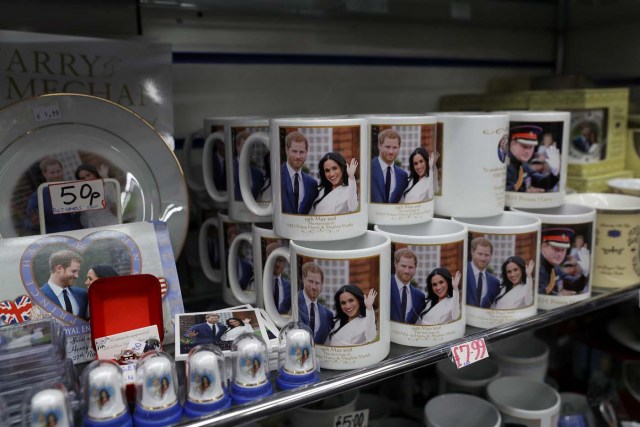 Souvenirs featuring Britain's Prince Harry and his fiancee Meghan Markle sit on display in a shop near Windsor Castle in Windsor, Britain, April 1, 2018. Picture taken April 1, 2018. REUTERS/Simon Dawson