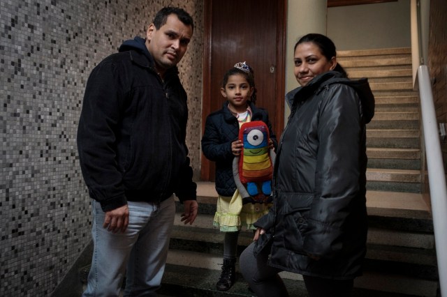 Venezuelans Fernando Sabatino (L), his wife Francis Fernandez (R) and their daughter Danyelys pose in Vigo, northwestern Spain, on March 14, 2018. Decades ago, they left their homes in northwestern Spain in their thousands for Venezuela, fleeing poverty or attracted by promises of oil riches. Now, many are coming back to Galicia -- or at least their descendants are -- escaping an acute crisis in Venezuela for the remote Spanish region, lured by authorities there who want to attract younger people, faced as they are with an ageing population. / AFP PHOTO / Miguel Riopa