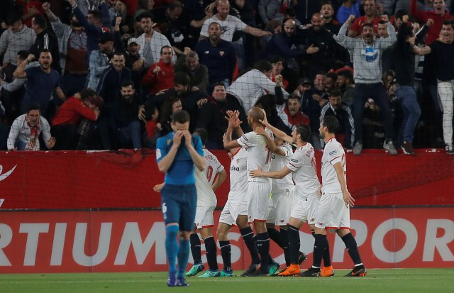 Soccer Football - La Liga Santander - Sevilla vs Real Madrid - Ramon Sanchez Pizjuan, Seville, Spain - May 9, 2018   Sevilla's Miguel Layun celebrates scoring their second goal with team mates as Real Madrid's Nacho looks dejected     REUTERS/Jon Nazca