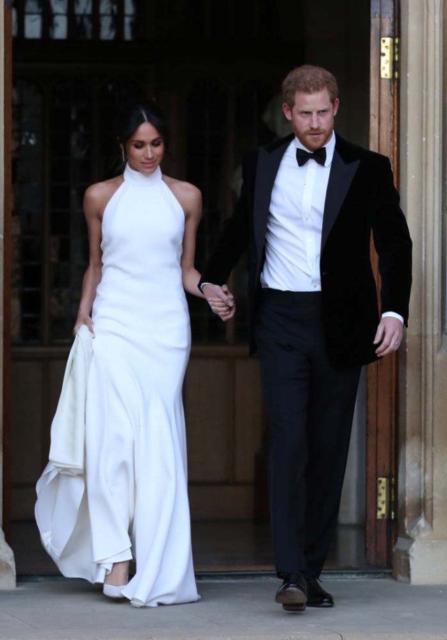 The newly married Duke and Duchess of Sussex, Meghan Markle and Prince Harry, leaving Windsor Castle after their wedding to attend an evening reception at Frogmore House, hosted by the Prince of Wales Windsor, Britain, May 19, 2018. Steve Parsons/Pool via REUTERS