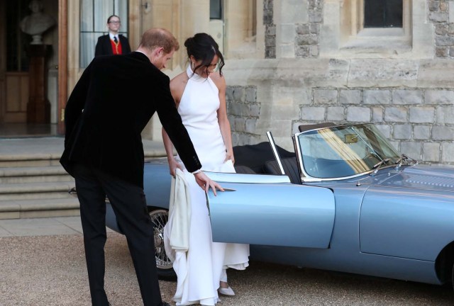 The newly married Duke and Duchess of Sussex, Meghan Markle and Prince Harry, leaving Windsor Castle after their wedding to attend an evening reception at Frogmore House, hosted by the Prince of Wales Windsor, Britain, May 19, 2018. Steve Parsons/Pool via REUTERS