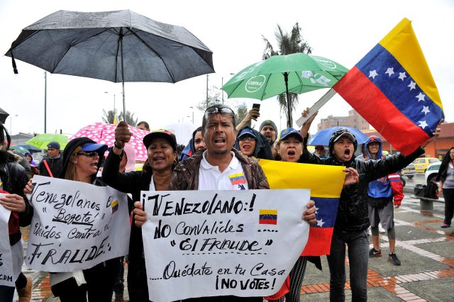 Venezuelan citizens living in Colombia protest against the presidential elections in Venezuela, in Bogota, Colombia May 20, 2018. The banner reads: "Venezuelan! Do not validate fraud. Stay at your home. Do not vote!" REUTERS/Carlos Julio Martinez